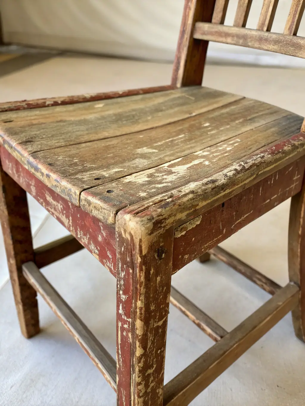 A close-up image of a beautifully preserved antique wooden chair, highlighting the intricate carvings and the rich patina of the wood, displayed in the furniture exhibit.